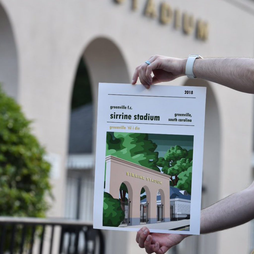 A retro football poster of Sirrine Stadium, South Carolina, being held up in front of the home ground of Greenville FC