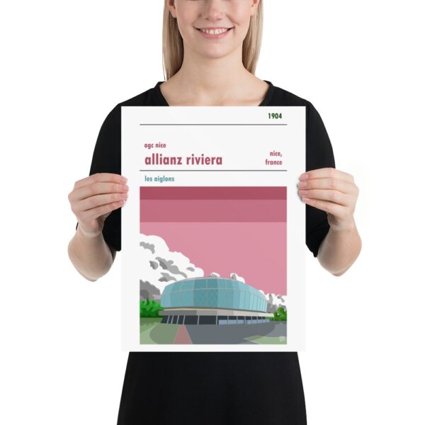 A woman holding a football poster of Stade de Nice and Nice FC