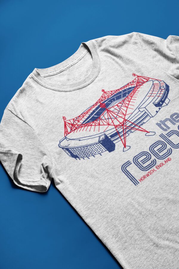 Grey t-shirt with blue and red Reebok Stadium graphic laying flat on a surface.