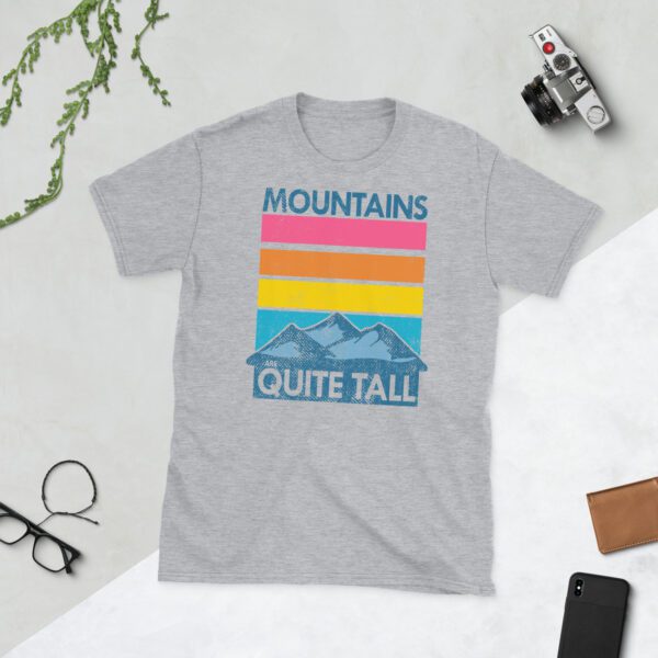 Grey-colored men's tee shirt laid out flat with mountain graphic and 'Mountains are quite tall' text.