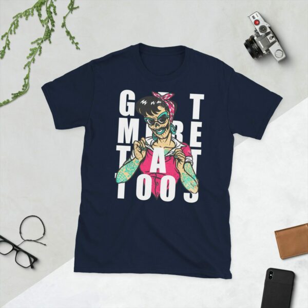 A navy t-shirt showing a graphic of a tattooed lady with the slogan Get More Tattoos on it.