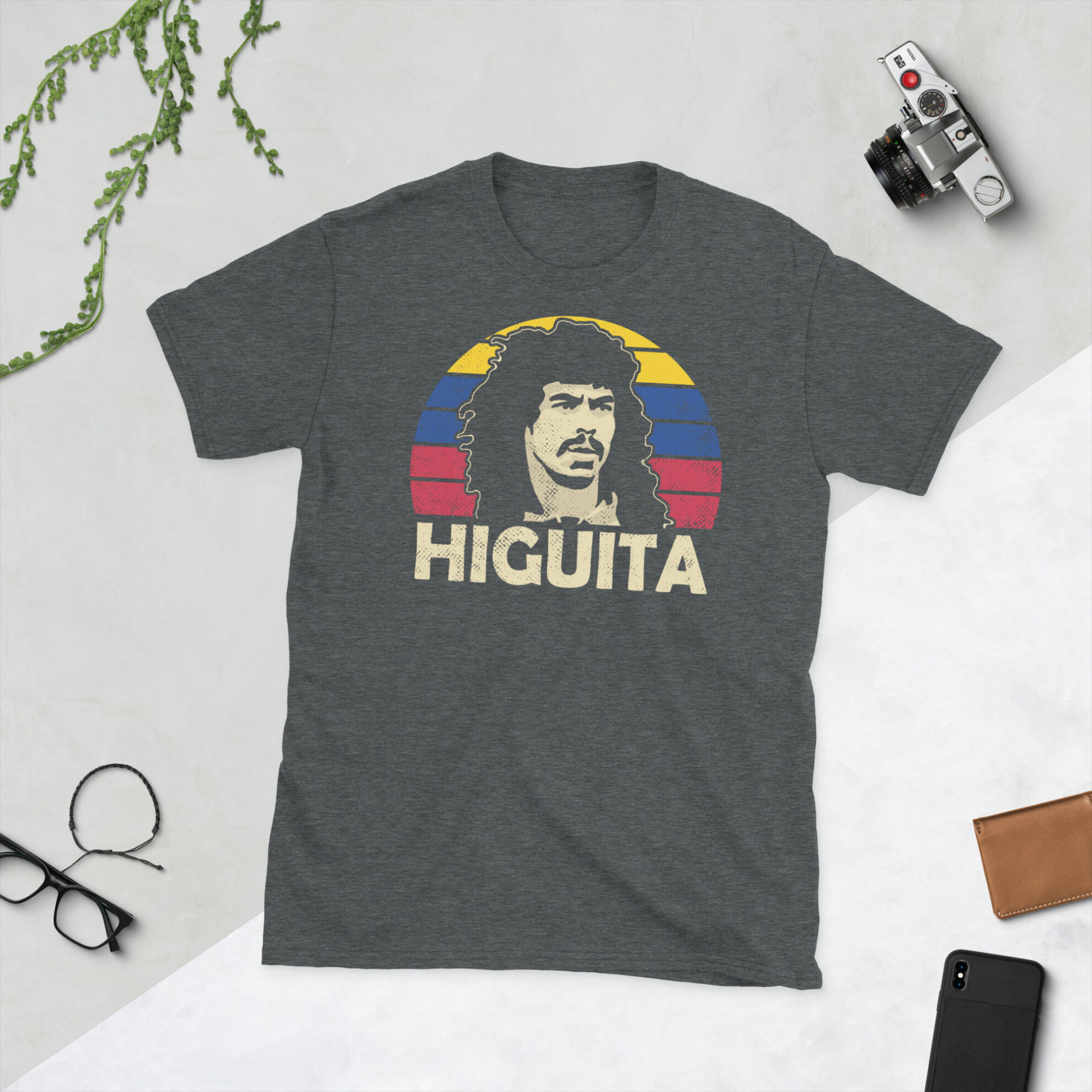 René Higuita Colombia T-Shirt in Heather - A heather grey T-shirt featuring a Colombia sunburst graphic and the word "HIGUITA" in the colours of the Columbian flag, commemorating Colombian football legend René Higuita.