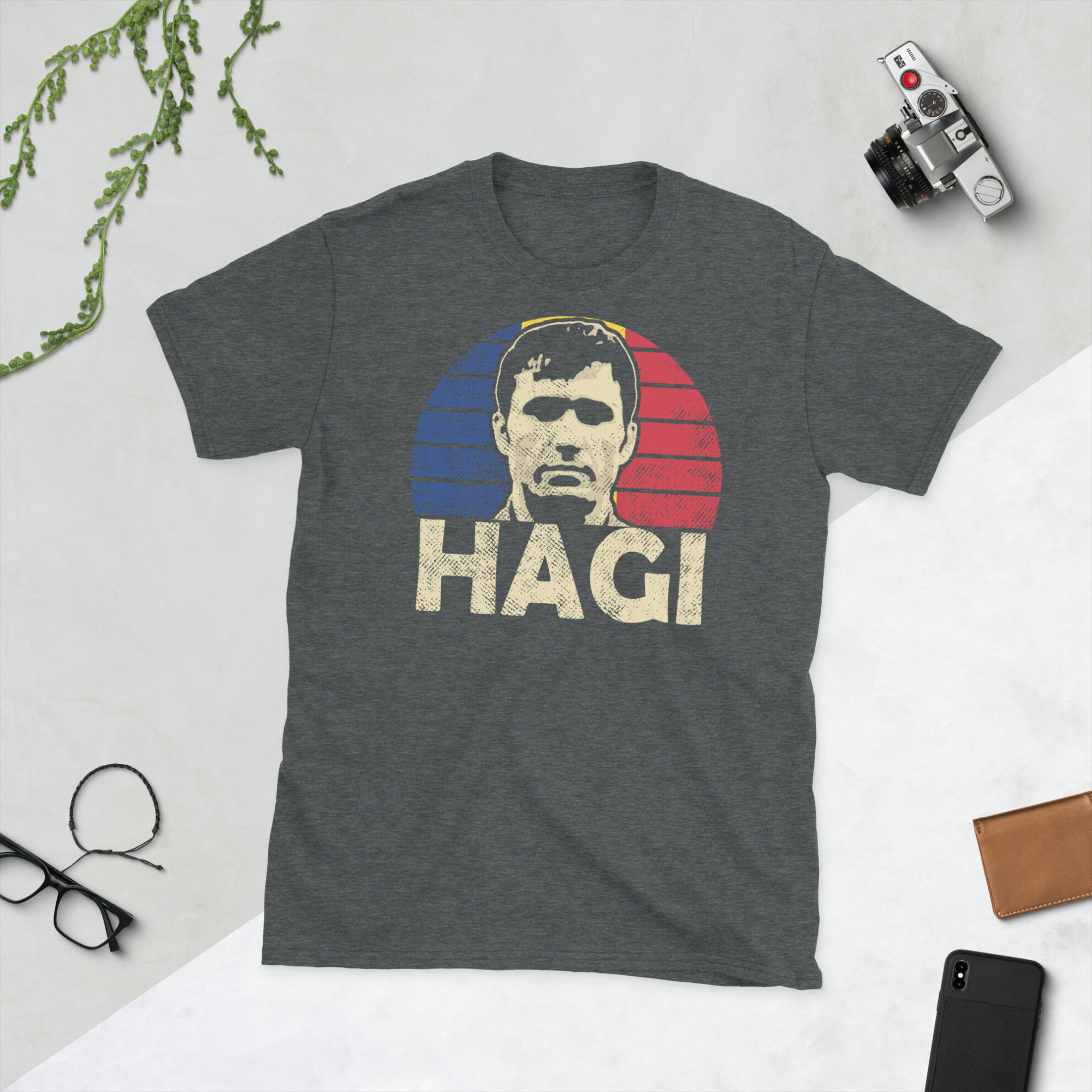 Gheorghe Hagi T-Shirt in Heather: A heather grey T-shirt featuring a Romanian sunburst and the word "HAGI" in bold, commemorating Romanian football legend Gheorghe Hagi.