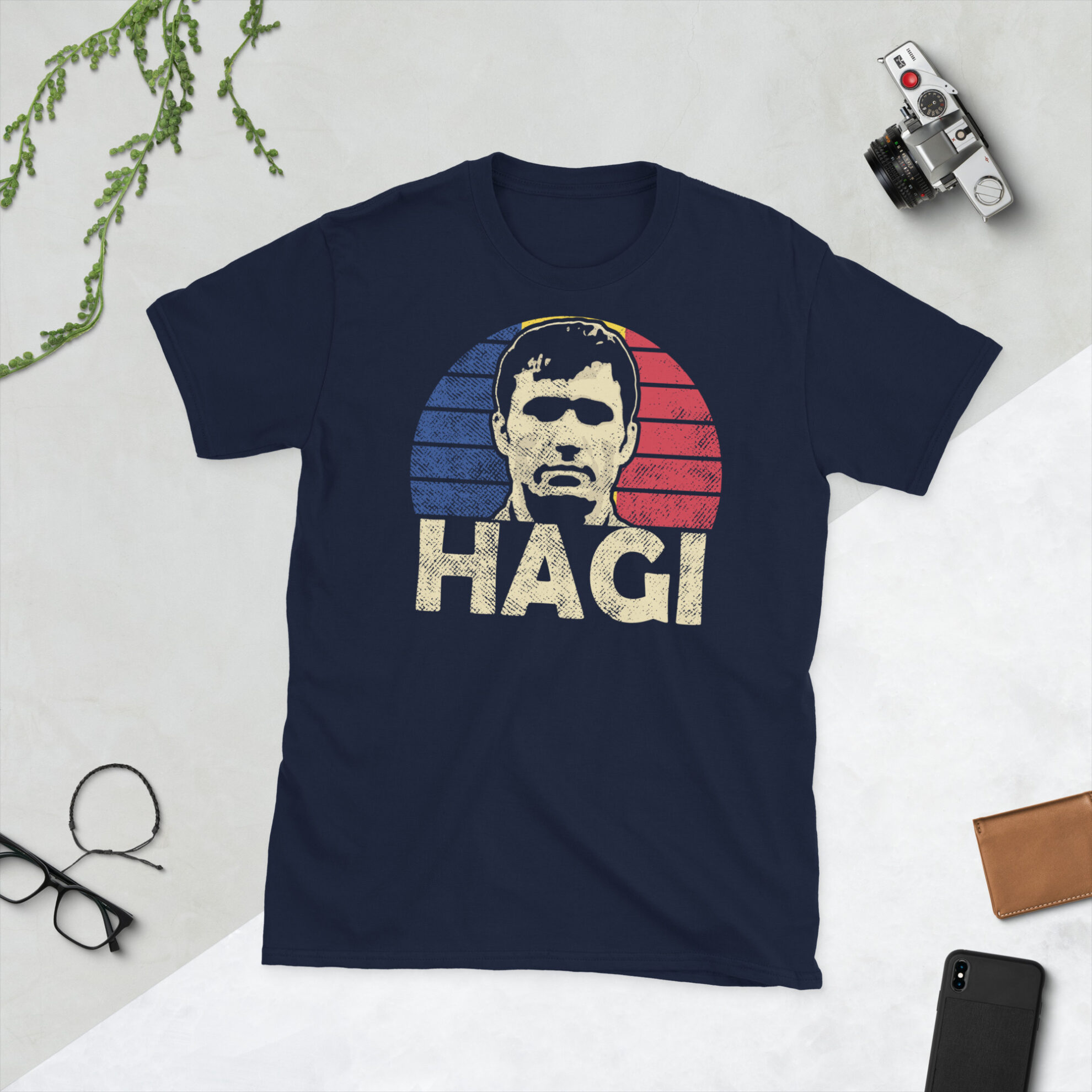 Gheorghe Hagi T-Shirt in Navy: A navy T-shirt featuring a Romanian sunburst and the word "HAGI" in bold, paying tribute to Romanian football legend Gheorghe Hagi.