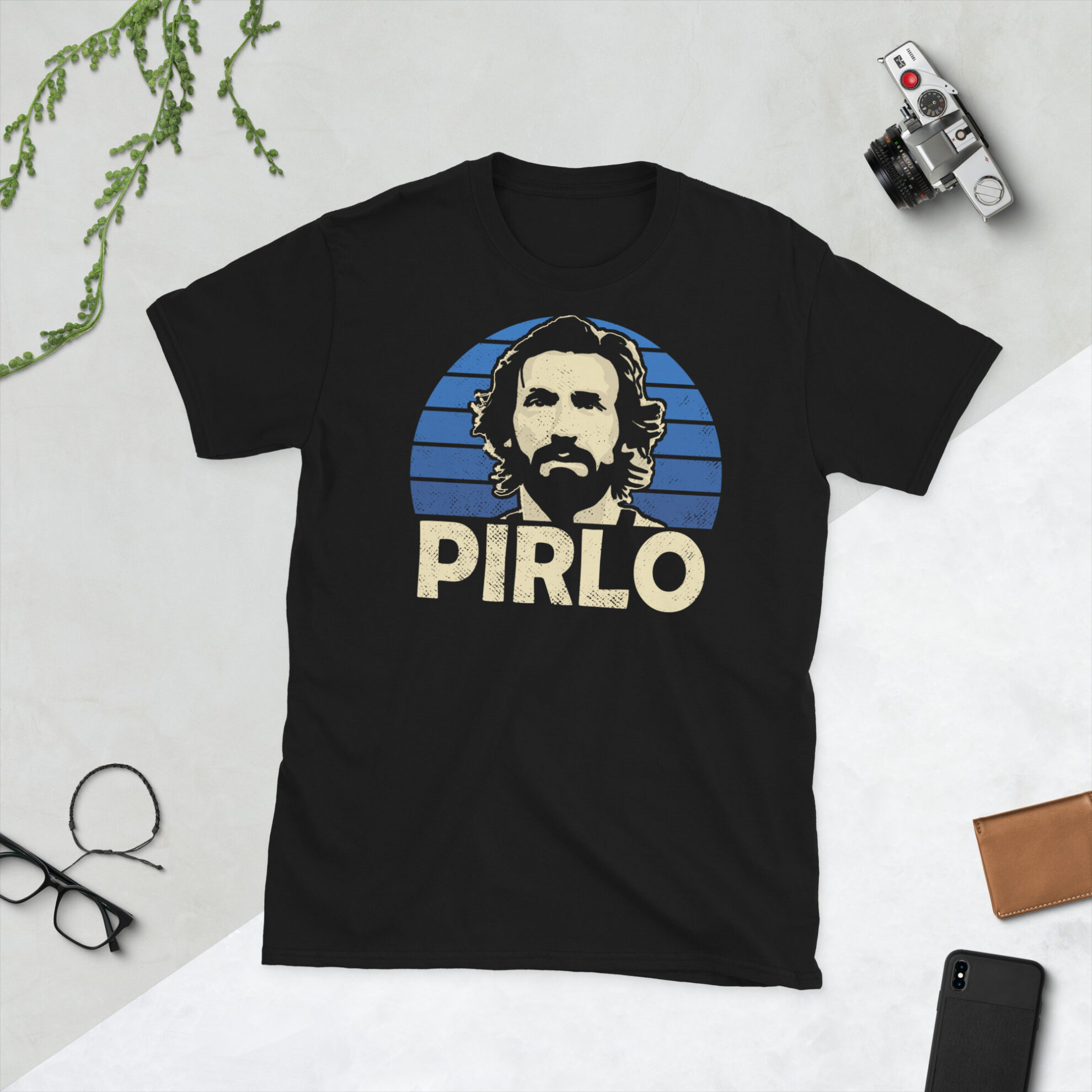 A black Andrea Pirlo T-Shirt featuring a blue sunburst design (inspired by the Italy national team colours) and "PIRLO" printed prominently in bold.