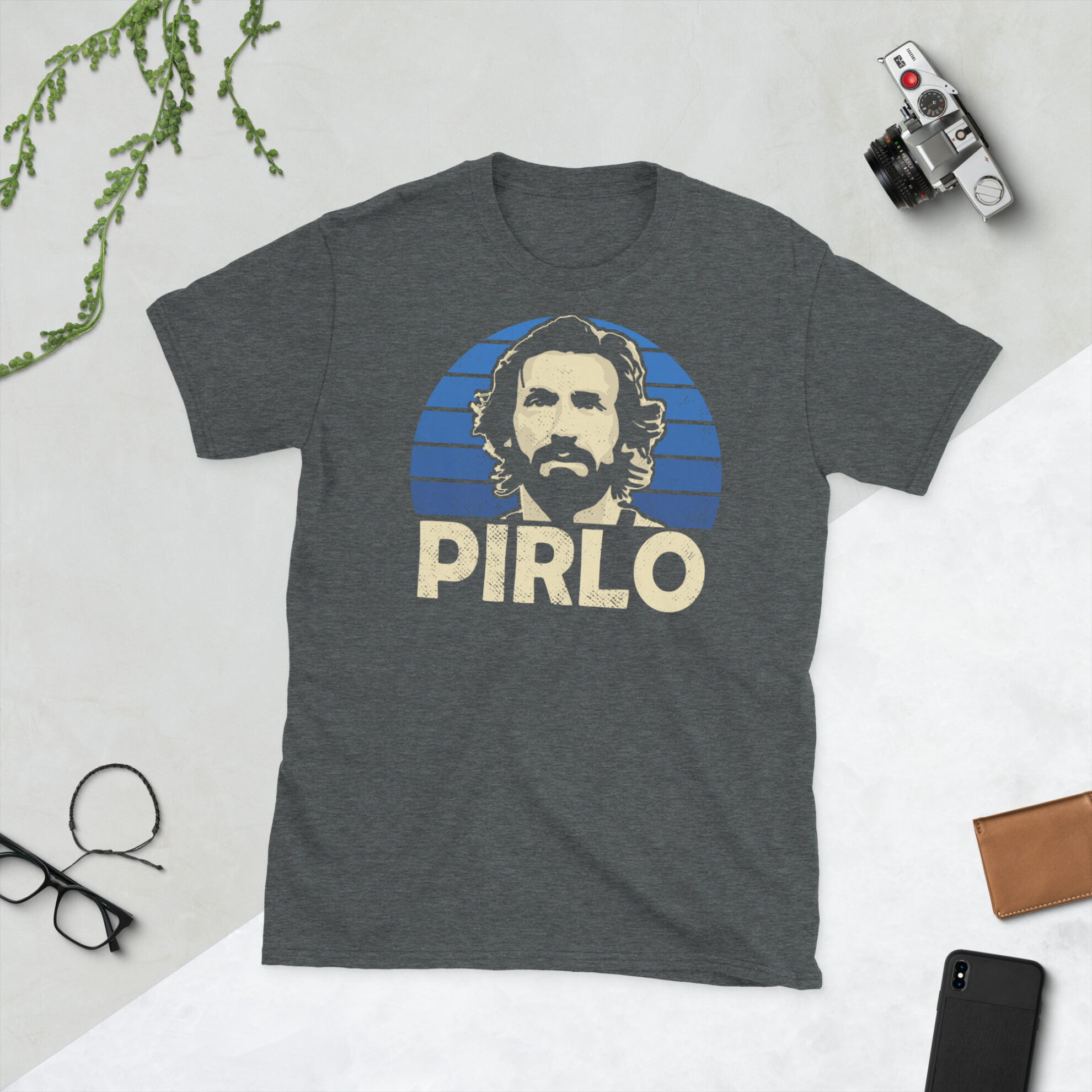 A grey Andrea Pirlo T-Shirt featuring a blue sunburst design (inspired by the Italy national team colours) and "PIRLO" printed prominently in bold.