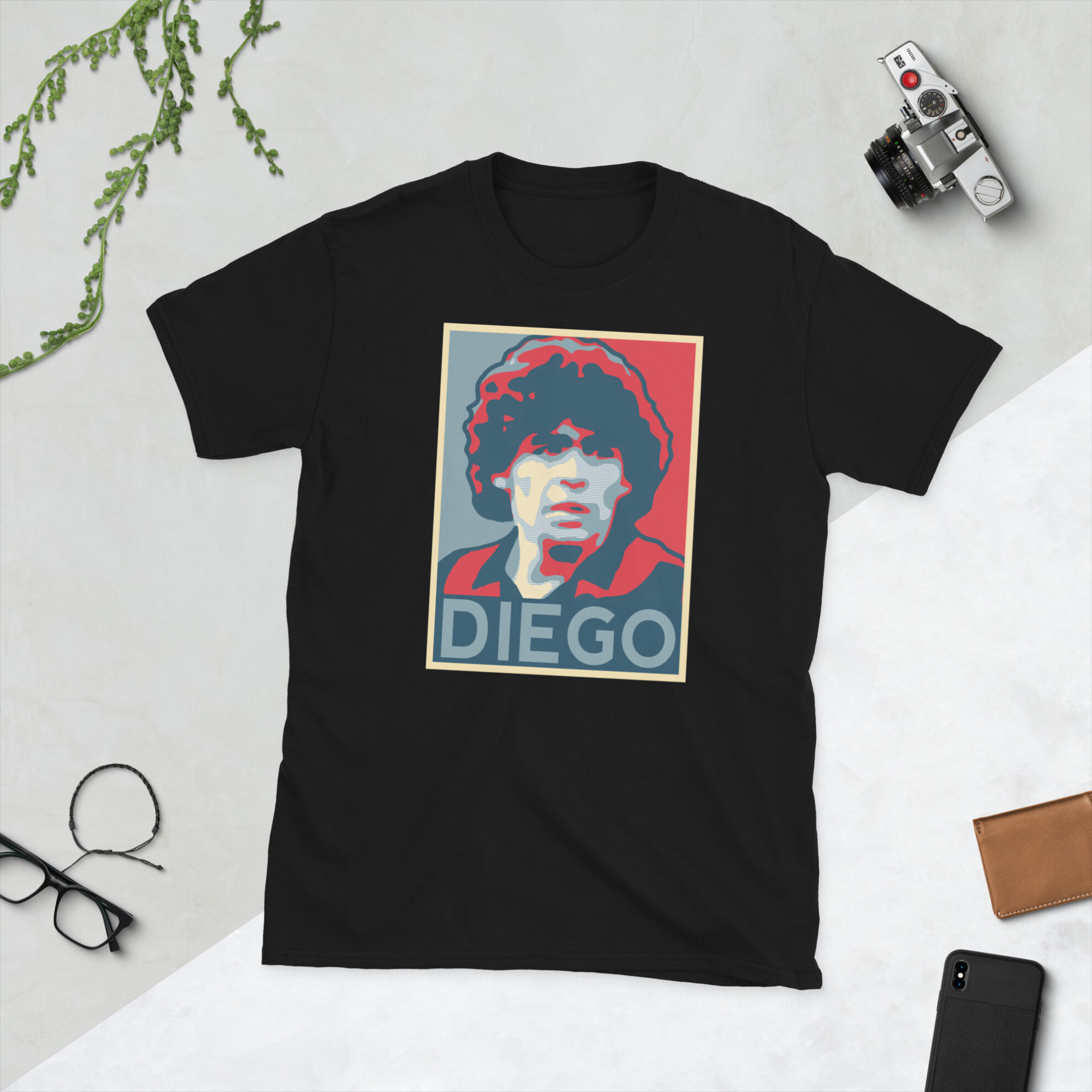 A black Diego Maradona T-Shirt featuring a graphic portrait of Diego Maradona, similar to the Obama "HOPE" campaign poster, with "DIEGO" written below him in bold lettering.