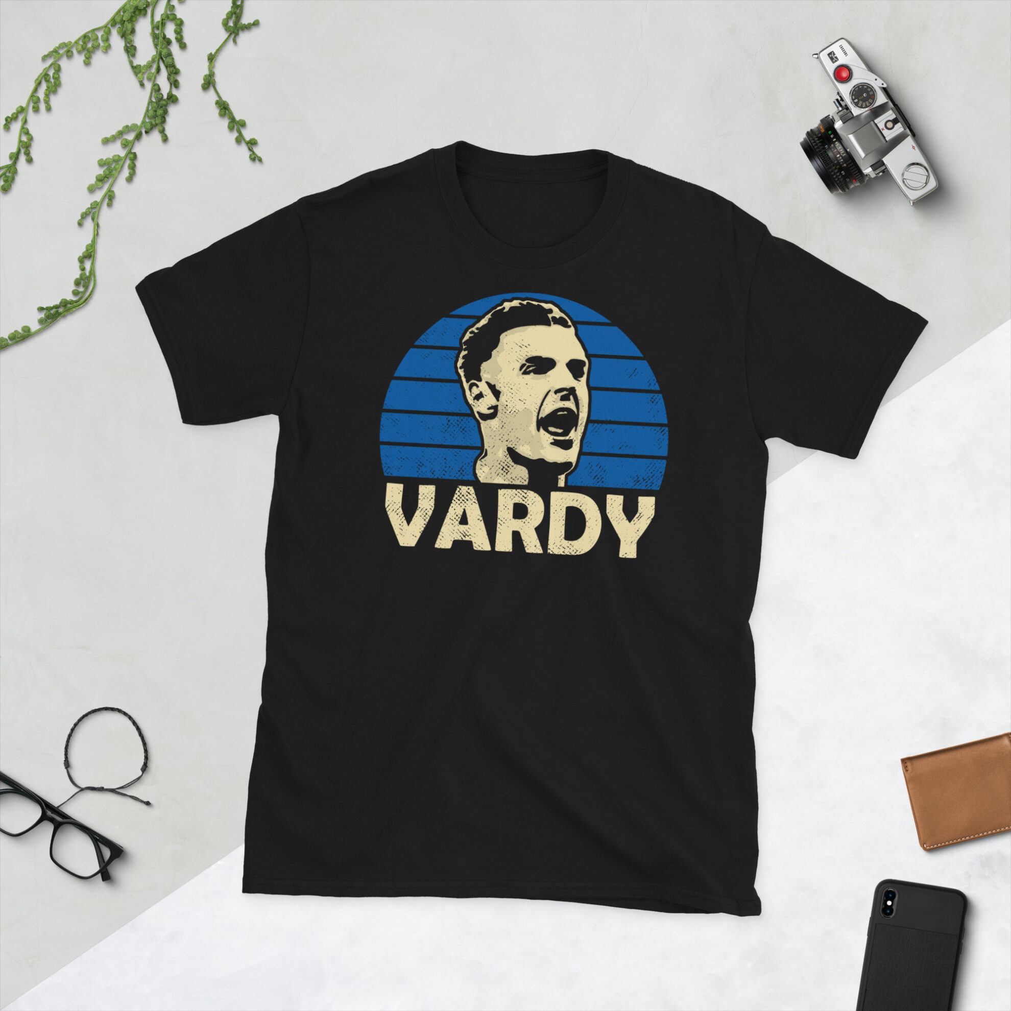 A black Jamie Vardy T-Shirt featuring a blue sunburst design (inspired by Leicester City colours) and "VARDY" printed prominently in bold.