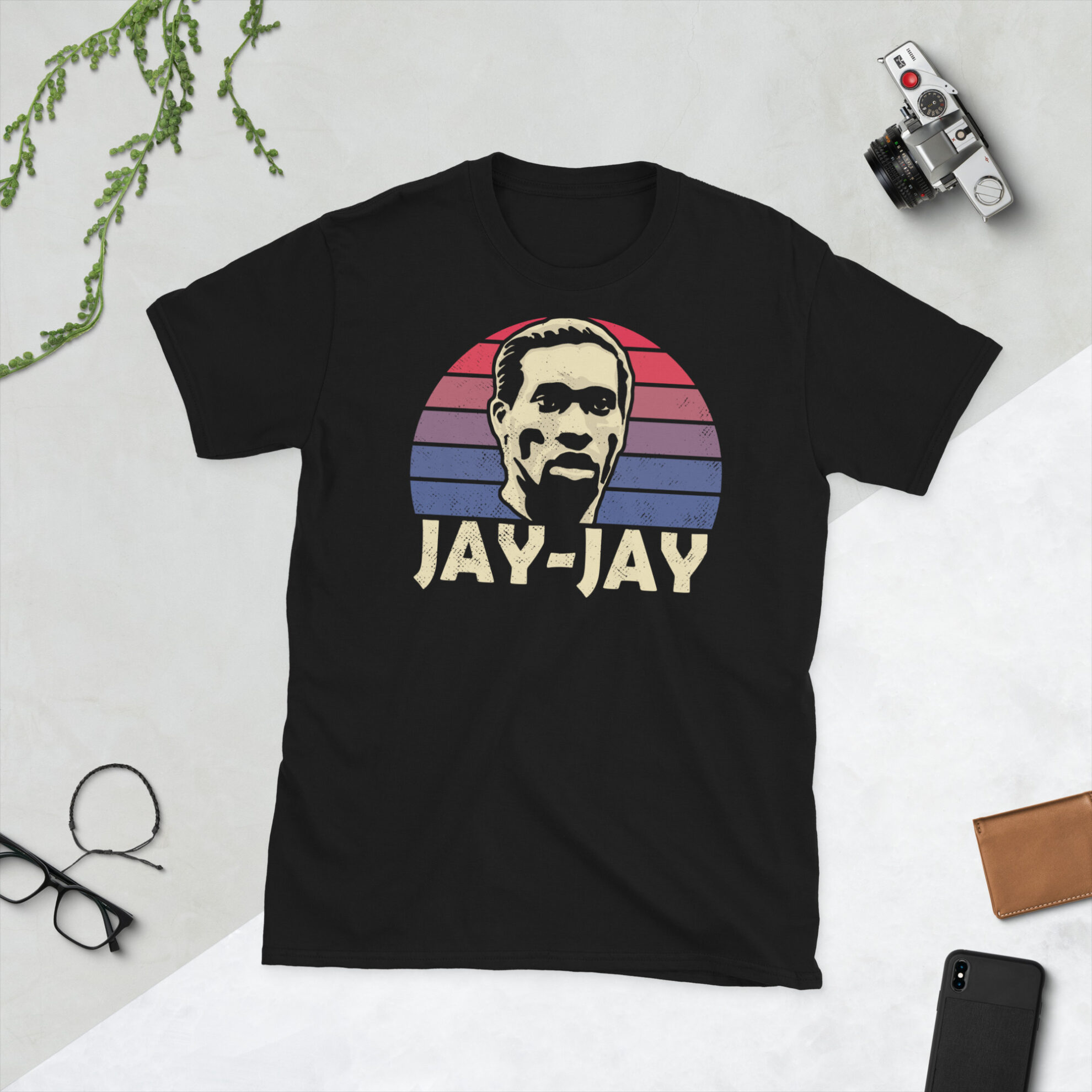A black Jay-Jay Okocha T-Shirt featuring a red and blue sunburst design (inspired by the Bolton Wanderers badge colours) and "JAY-JAY" printed prominently in bold.