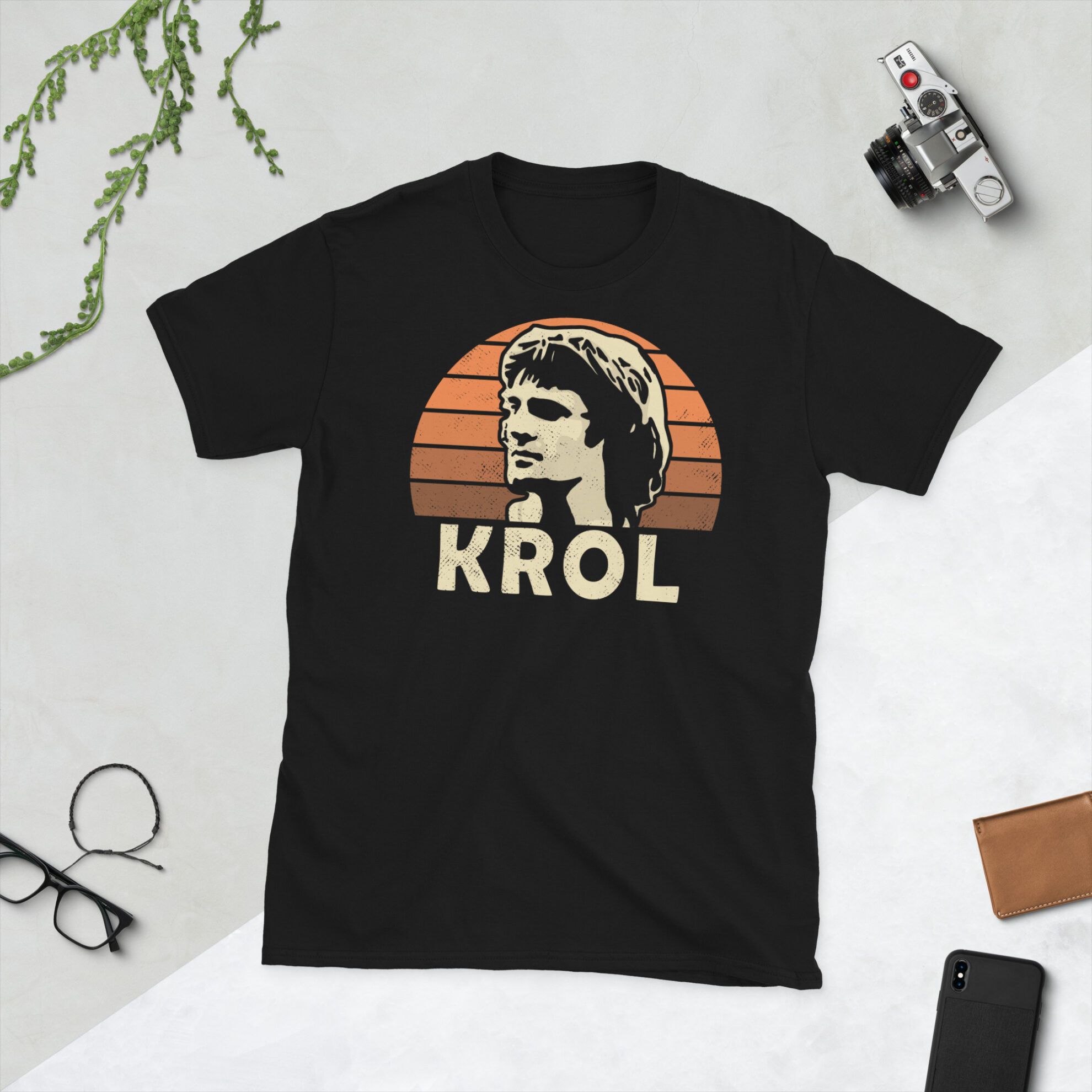 A black Ruud Krol T-Shirt featuring an orange sunburst design (inspired by the Netherlands national team colours) and "KROL" printed prominently in bold.