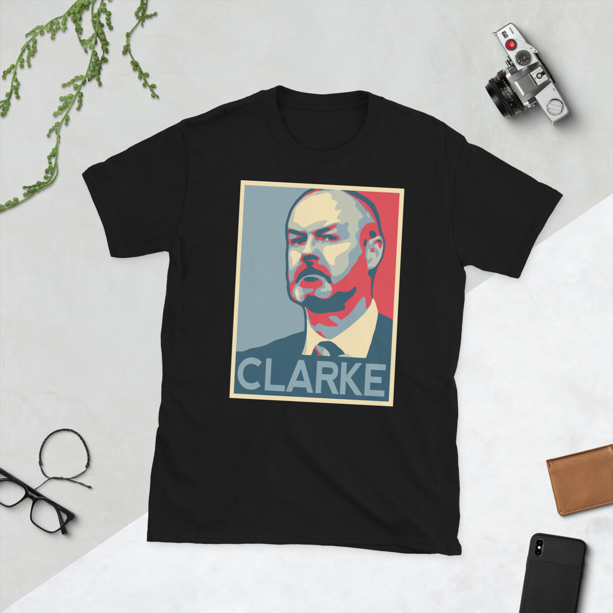A black Steve Clarke T-Shirt featuring a graphic portrait of Steve Clarke, similar to the Obama "HOPE" campaign poster, with "CLARKE" written below him in bold lettering.