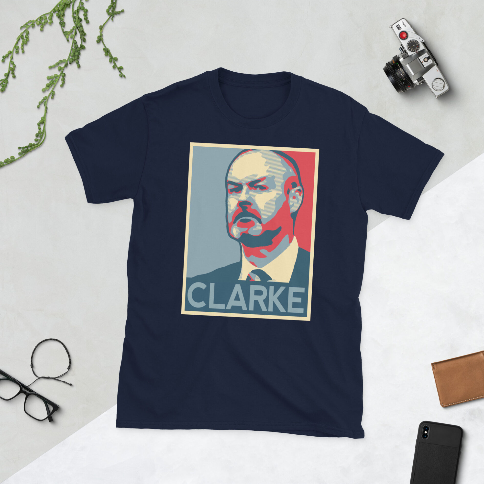 A navy Steve Clarke T-Shirt featuring a graphic portrait of Steve Clarke, similar to the Obama "HOPE" campaign poster, with "CLARKE" written below him in bold lettering.