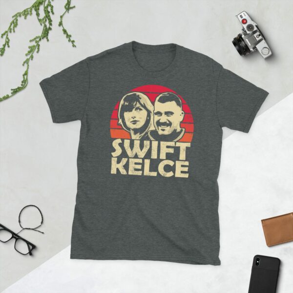 Show your love for Taylor Swift and Travis Kelce with this heather grey T-shirt. It features silhouette graphics of Swift and Kelce with a red and yellow sunburst design.