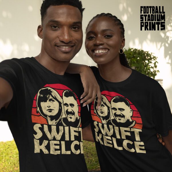 A smiling couple wearing matching black t-shirts featuring Taylor Swift and Travis Kelce
