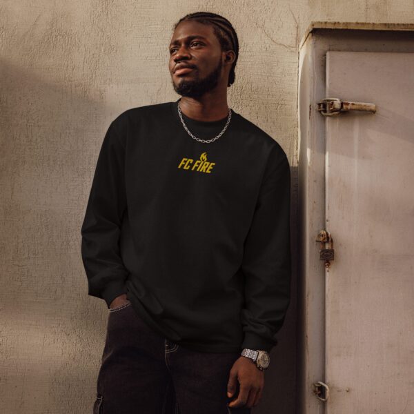 A stylish Black man in FC Fire’s black premium embroidered long-sleeve sweater – Enfield’s high-end football fashion for men
