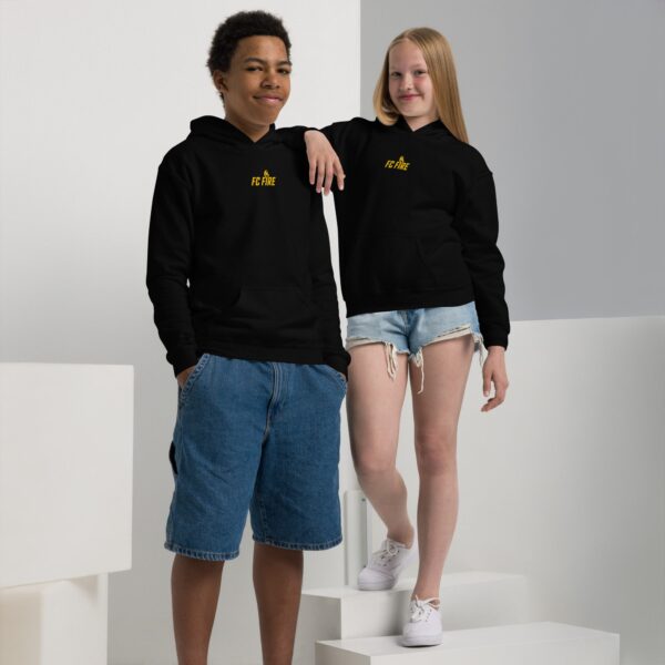 Boy and girl wearing matching black FC Fire embroidered football hoodies – premium youth streetwear from Enfield, UK