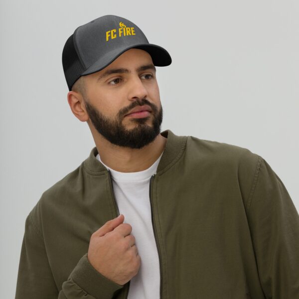 A man with a beard wearing a dark heather FC Fire retro trucker hat with gold embroidered logo – adjustable football cap