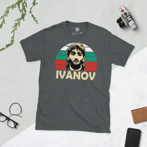 A subtle dark heather T-shirt emblazoned with a stylised portrait of 'The Wolfman', Trifon Ivanov. The iconic Bulgarian flag colours (white, green, red) emanate from behind his head, and his name "IVANOV" anchors the design below.