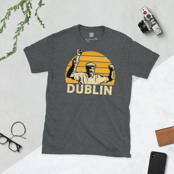 A dark heather Dion Dublin T-shirt featuring a yellow sunburst design with "DUBLIN" written under the main graphic.