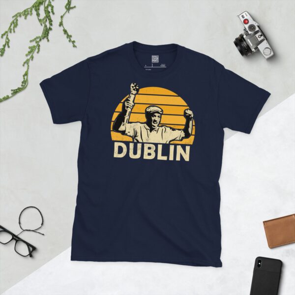 Celebrate Cambridge United legend Dion Dublin with this navy blue tee. It features a striking yellow sunburst design with "DUBLIN" written under the main graphic.