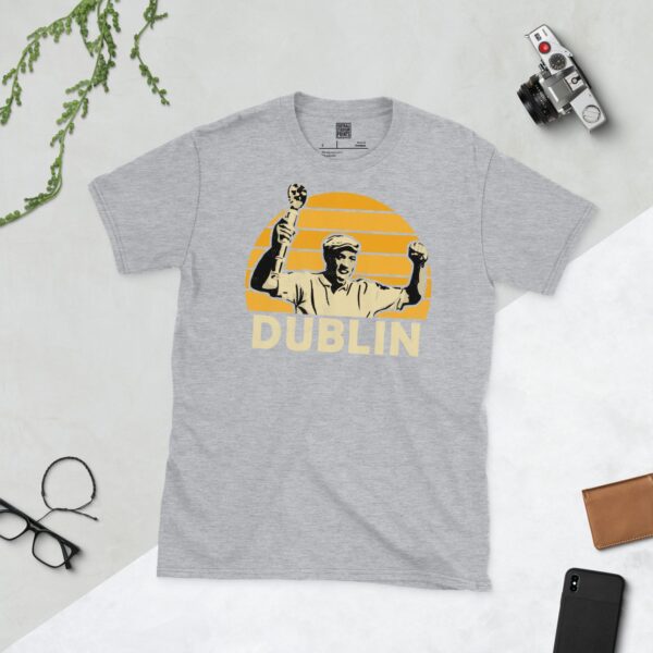 A sports grey Dion Dublin T-shirt featuring a yellow sunburst design with "DUBLIN" written under the main graphic.