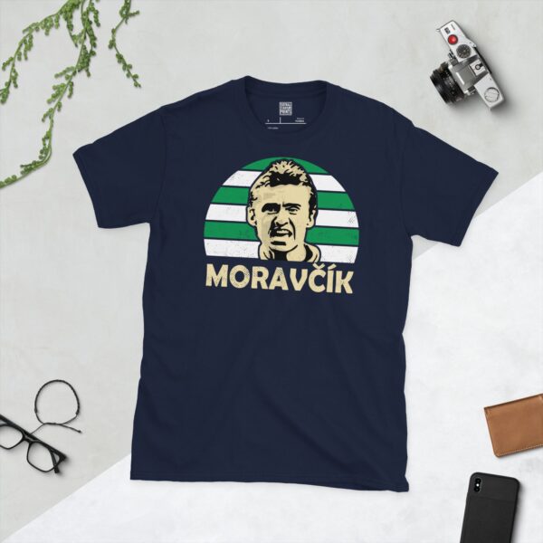 Celebrate Celtic legend Lubo Moravcik with this navy blue tee. It features a striking green and white striped sunburst design with "MORAVCIK" written under the main graphic.