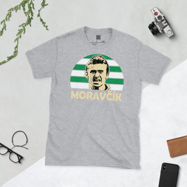 A sports grey Lubo Moravcik T-shirt featuring a green and white striped sunburst design with "MORAVCIK" written under the main graphic.
