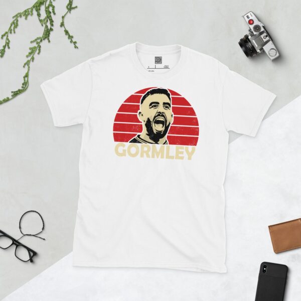 Show your Cliftonville FC pride in this white Joe Gormley T-shirt. It features a red sunburst design with "GORMLEY" written under the main graphic.