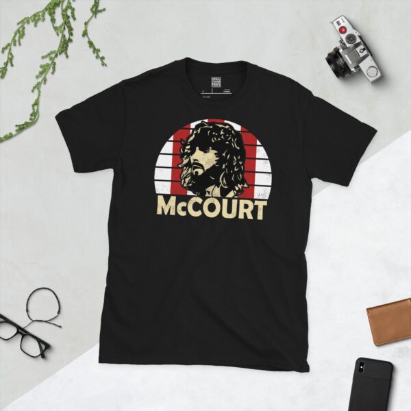 A black Paddy McCourt T-shirt featuring a red and white striped sunburst design with "McCOURT" written under the main graphic.