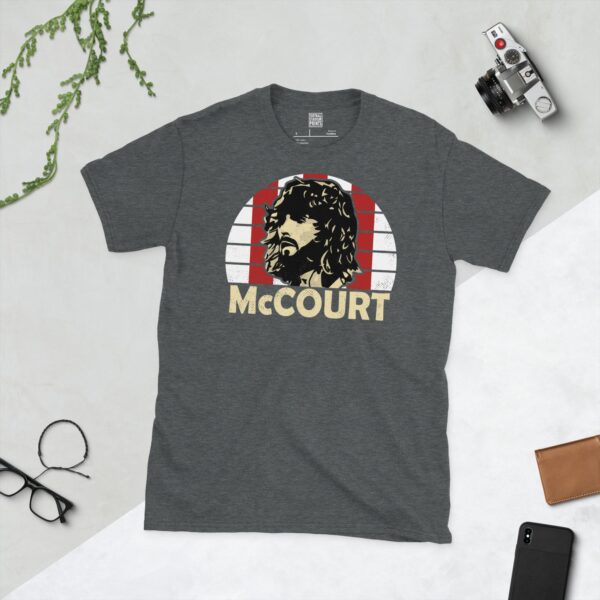 A dark heather Paddy McCourt T-shirt featuring a red and white striped sunburst design with "McCOURT" written under the main graphic.