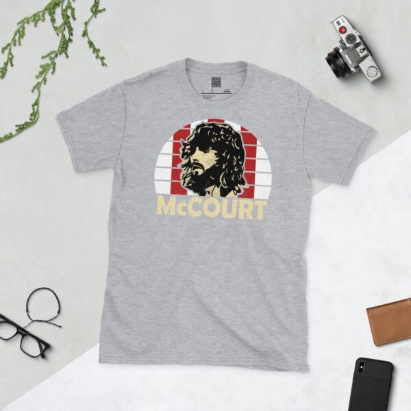 A sports grey Paddy McCourt T-shirt featuring a red and white striped sunburst design with "McCOURT" written under the main graphic.