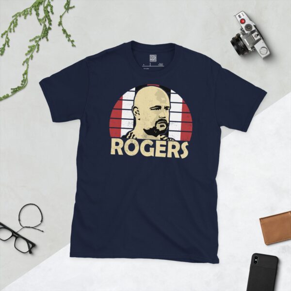 Celebrate England Amputee National Football Team manager Scott Rogers with this navy blue tee. It features a striking red, white, and black sunburst design with "ROGERS" written under the main graphic.