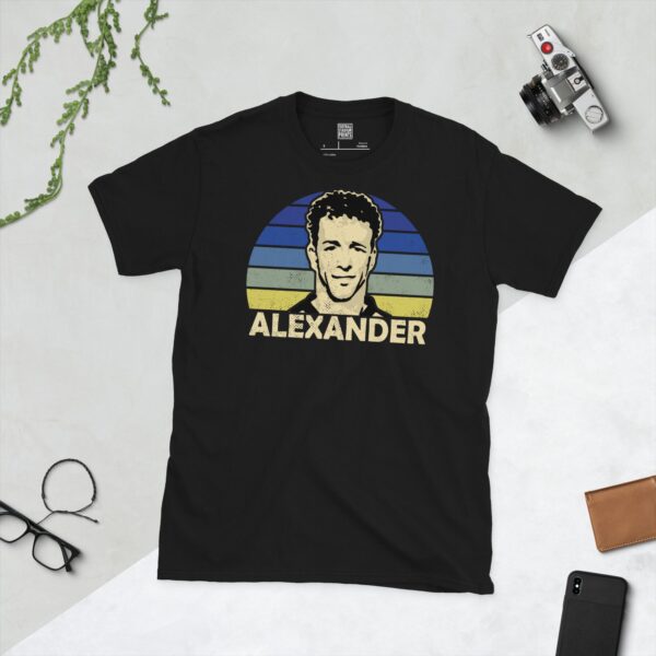 A black Rowan Alexander T-shirt featuring a blue fading to yellow sunburst design with "ALEXANDER" written under the main graphic.