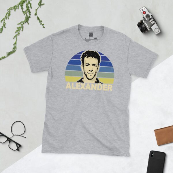 A sports grey Rowan Alexander T-shirt featuring a blue fading to yellow sunburst design with "ALEXANDER" written under the main graphic.