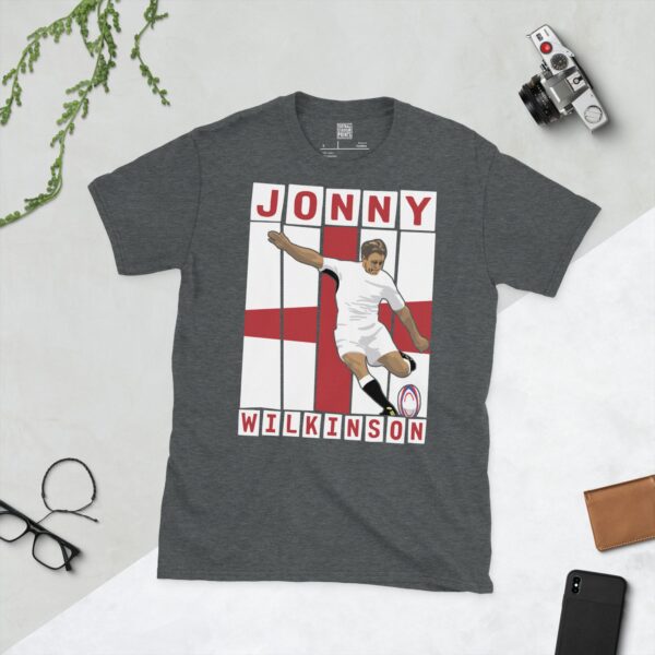 A dark heather T-shirt featuring a graphic of England rugby legend Jonny Wilkinson in his distinctive pose, taking a kick.