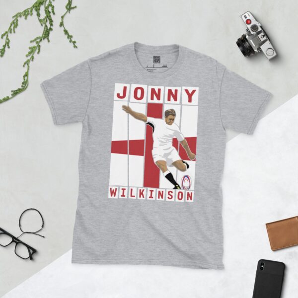A sports grey T-shirt featuring a graphic of England rugby legend Jonny Wilkinson in his distinctive pose, taking a kick.