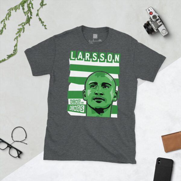 A subtle dark heather T-shirt emblazoned with a striking portrait of Henrik Larsson, a key figure in Celtic's history. The design incorporates the famous green and white Hoops behind his image, alongside his name "LARSSON" and the fitting title "KING OF KINGS".
