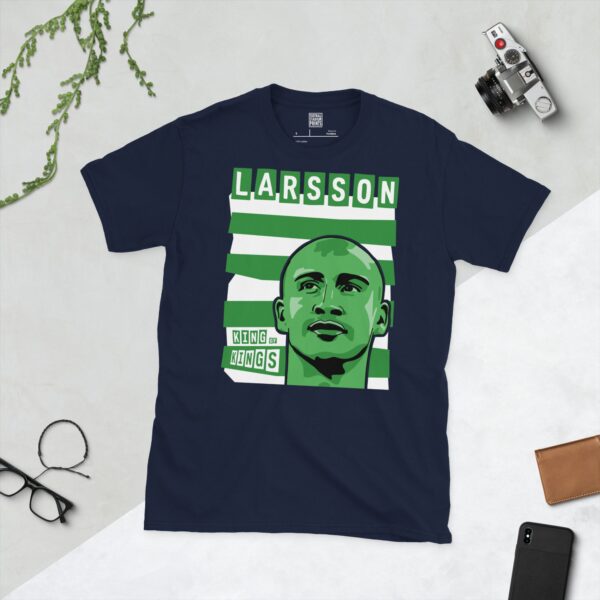 A deep navy blue T-shirt featuring a compelling graphic of Henrik Larsson, the legendary Celtic forward, set against a backdrop of bold green and white horizontal stripes. His surname "LARSSON" and the iconic phrase "KING OF KINGS" are clearly visible.