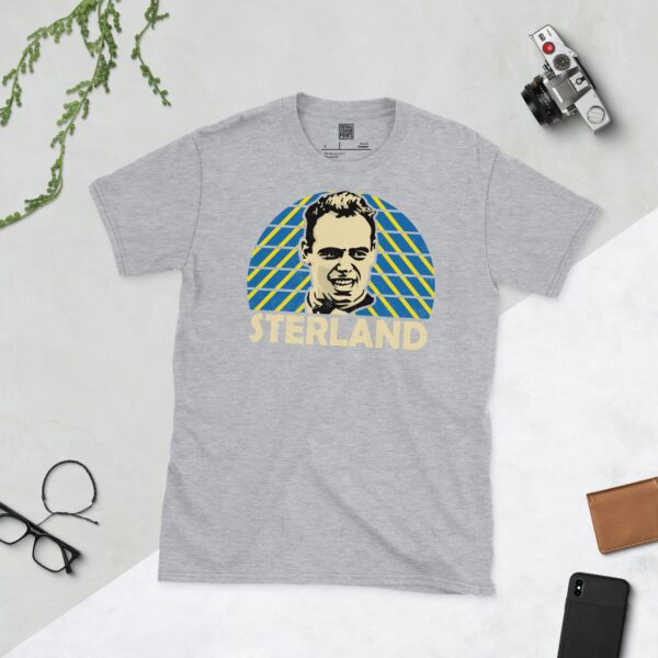 A versatile sports grey T-shirt showcasing a vibrant illustration of Leeds United legend Mel Sterland. The design incorporates a dynamic blue and yellow sunburst pattern, reflecting the club's colours, with "STERLAND" clearly visible underneath.