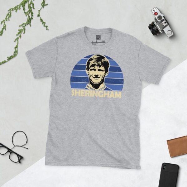 A sports grey Teddy Sheringham T-shirt featuring a blue sunburst design with "SHERINGHAM" written under the main graphic.