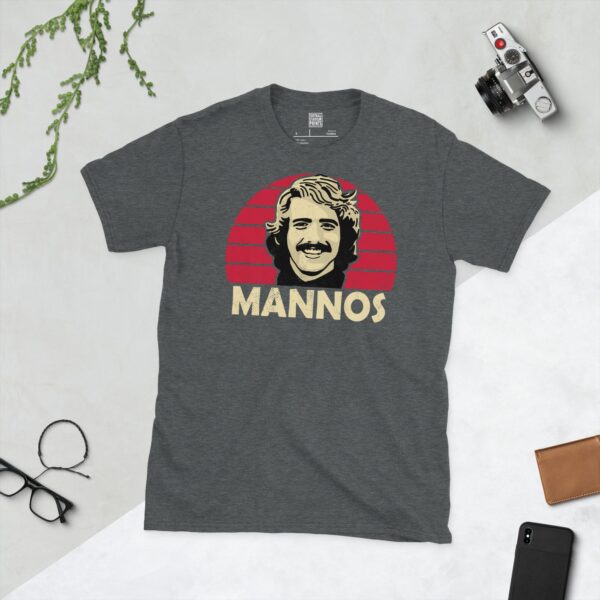A dark heather Peter Mannos T-shirt featuring a Cardinal red sunburst design with "MANNOS" written under the main graphic.