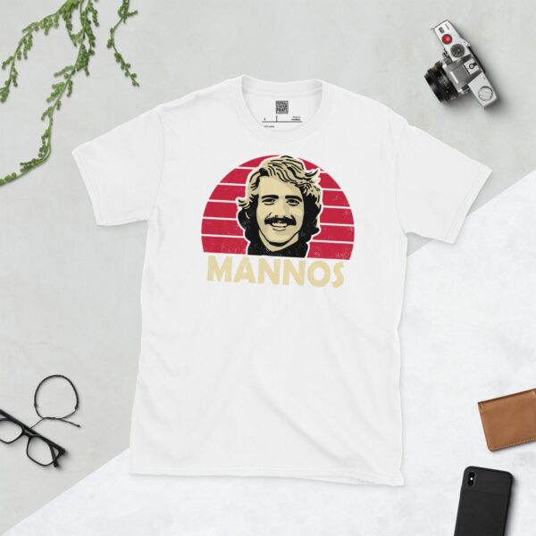 Show your Northern Illinois University pride in this white Peter Mannos T-shirt. It features a Cardinal red sunburst design with "MANNOS" written under the main graphic.