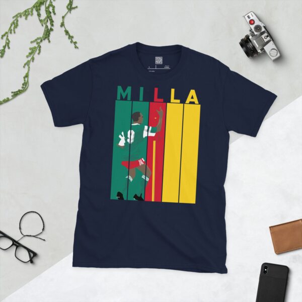 Celebrate the legendary Roger Milla with this navy blue tee. It features a striking striped design in Cameroon flag colours, with "MILLA" above five pillars and a graphic of Roger Milla doing his iconic corner flag dance from the 1990 World Cup.