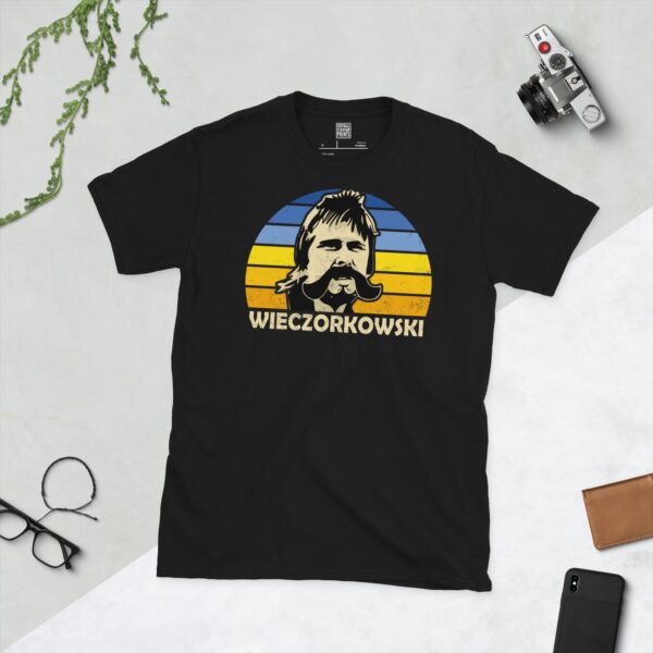 A black Gert Wieczorkowski T-shirt featuring a blue and yellow sunburst design with "WIECZORKOWSKI" written under the main graphic.