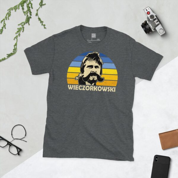 A dark heather Gert Wieczorkowski T-shirt featuring a blue and yellow sunburst design with "WIECZORKOWSKI" written under the main graphic.
