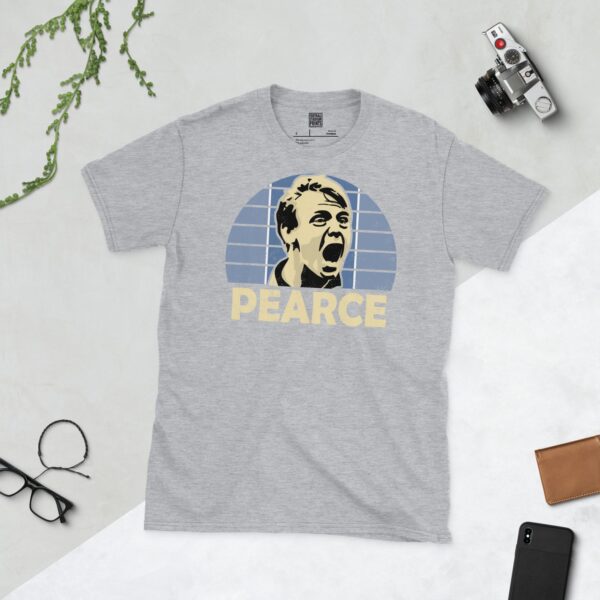 A versatile sports grey T-shirt showcasing a vivid illustration of Stuart Pearce, the renowned England defender. The design features his intense expression against a blue and white tiled pattern, with his name "PEARCE" prominently positioned underneath.