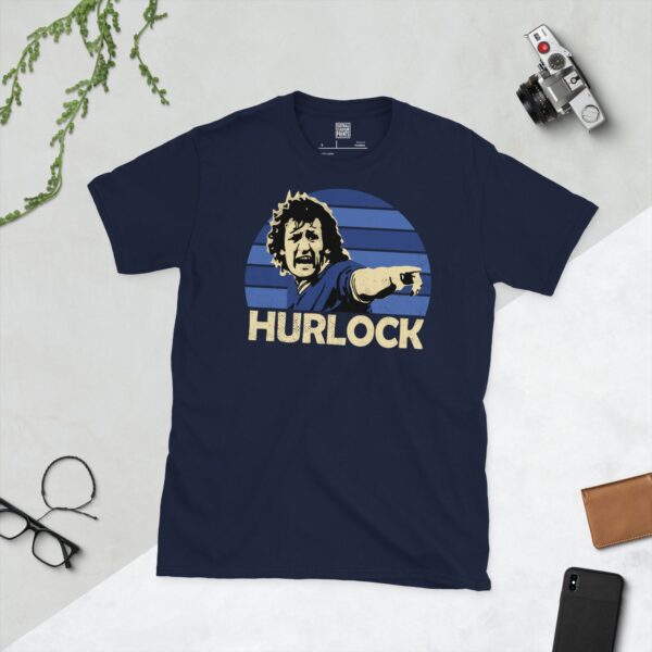 Celebrate Millwall legend Terry Hurlock with this navy blue tee. It features a striking blue sunburst design with "HURLOCK" written under the main graphic.