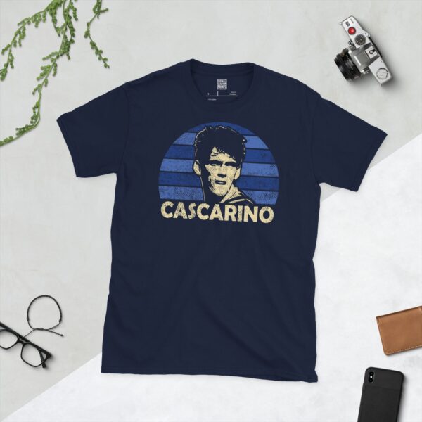 Celebrate Millwall legend Tony Cascarino with this navy blue tee. It features a striking blue sunburst design with "CASCARINO" written under the main graphic.