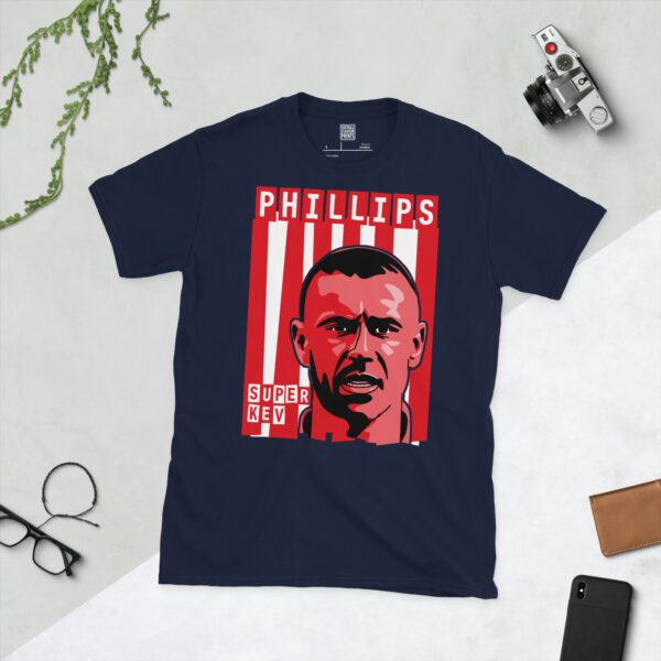 A deep navy blue T-shirt featuring a compelling graphic of Kevin Phillips, the legendary Sunderland forward, set against a backdrop of bold red and white vertical stripes. His surname "PHILLIPS" and the iconic phrase "SUPER KEV" are clearly visible, celebrating his status.
