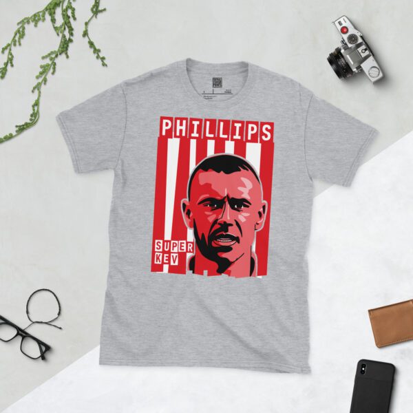 A versatile sports grey T-shirt showcasing a striking illustration of Kevin Phillips, the beloved Sunderland striker. The design includes his portrait over a vibrant red and white striped pattern, typical of the club's colours, with "PHILLIPS" and "SUPER KEV" defining the top and bottom of the graphic.